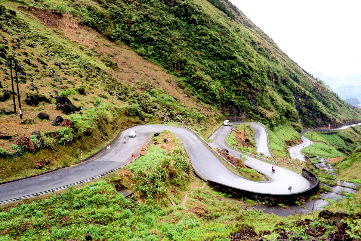 Dramatic view of Ma Pi Leng Pass with narrow cliffside roads overlooking the deep Nho Que River gorge in Ha Giang.